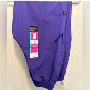 One pair of Scrubstar purple jogger scrub pants with pink seams. Size XL